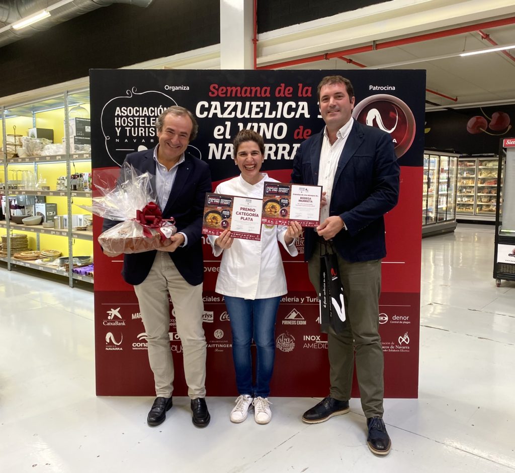 Recoge el premio la cocinera del Bar la Huerta de Chicha, le acompañan los representantes de las empresas que les entregan diploma y premio que consiste en un lote de productos cortesía de Cooperativa de Hostelería y una caja de vino de Bodegas Inurrieta.